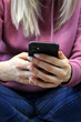 © Anna - girl on bed looking at smartphone screen. Selective focus