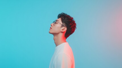 Leinwandbilder - Neon-Futuristic Tech Coding Young Asian Male Developer in Profile Against Vibrant Blue Gradient - Innovative Digital Content and AI-Powered Cloud Solutions for Progressive Businesses