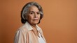 © Alteisen Riese - elderly hispanic female in casual wear on pastel color background model portrait looking serious for ad concept space for text