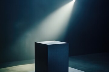 Poster - A bright light illuminates a black pedestal, creating a striking contrast