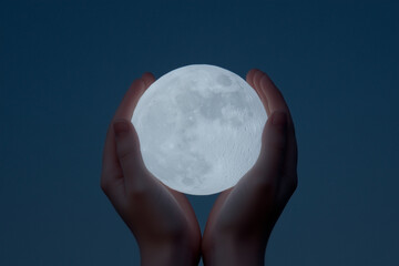 Wall Mural - Full Moon Held in Hands Against Dark Blue Background