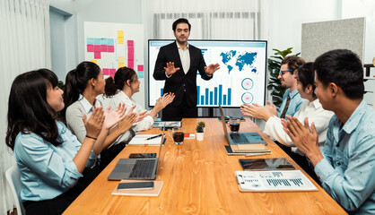 Poster - Group of happy multi ethnic businesspeople in celebratory gesture and successful teamwork after made success sales or positive financial data dashboard display on screen in meeting room. Habiliment