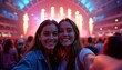 © Viktor - Two young women enjoy concert in giant indoor arena. Taking selfie smiling at camera. Arena filled with people enjoying show. Fireworks going off on stage. Vibrant, fun night out.