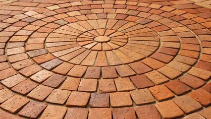 Poster - A closeup of a circular brick design built from handcrafted terracotta bricks highlighting the smooth rounded edges and warm hues. The intricate arrangement draws the eye to the
