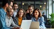 © Viktor - Diverse team of professionals in modern office setting. Employees work together on laptops. Happy, engaged, collaborating. Modern business workplace. Team interaction, tech use, pro environment.
