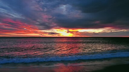 Wall Mural - dramatic red sunset and sea beach in dusk, tracking shot 4k