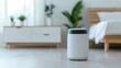 © AtomMaya - Modern Air Purifier in Bright Bedroom with Natural Light and Plants
