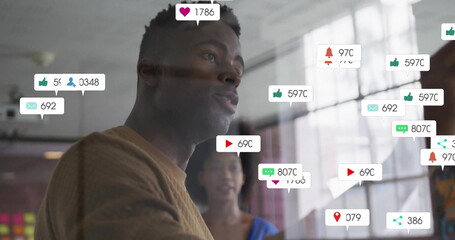 Poster - Image of social media notifications over african american colleagues discussing at casual office
