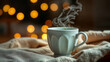 © Vic - Warm cup of steaming beverage sits cozy on soft blanket with glowing lights in background during a winter evening