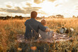 © kieferpix - Father and son bonding in nature sitting in meadow watching the sunset spending quality time together