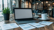 © CreativeIMGIdeas - Modern Workspace Mockup: A sleek laptop with blank screen sits open on a rustic wooden table, surrounded by scattered documents and a cup of coffee, creating a minimalist workspace.