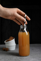 Wall Mural - Tamarind juice in a glass bottle on a dark background