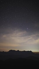 Wall Mural - night sky with moving stars above the northern landscape of chiang mai, thailand with the famous doi