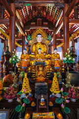 Wall Mural - There are many Buddhist golden Buddha statues inside a temple in a pagoda in Nha Trang, Asia