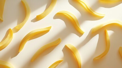 Aufkleber - Golden french fries arranged on a beige background, illuminated by sunlight casting shadows.
