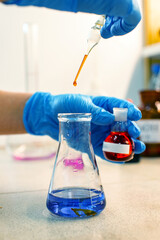 Poster - chemistry experiment involves mixing colored liquids in laboratory setting with precise droplet meas