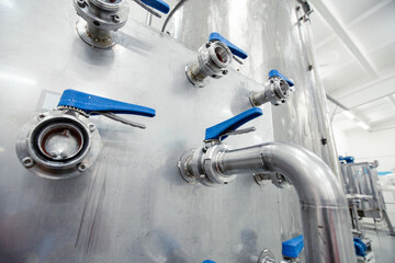 Poster - industrial piping system with blue valves showcased in a modern manufacturing facility during daylig