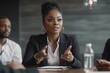 © Pixel Nexus - Black female boss leading corporate multiracial team meeting talking to diverse businesspeople, african american woman executive discussing project plan at group multi-ethnic briefing in boardroom, Ge