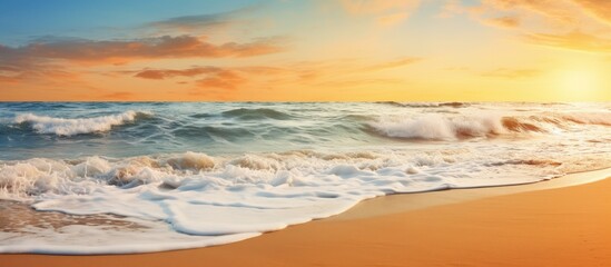 Wall Mural - golden sunset over tranquil ocean waves gently lapping sandy shore with pastel orange and blue hues 