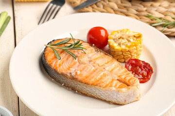 Wall Mural - Plate with tasty grilled salmon steak on light wooden background