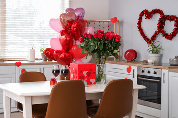 Wall Mural - Dining table with bouquet of roses, wine glasses and gift boxes in light kitchen. Valentine's Day celebration