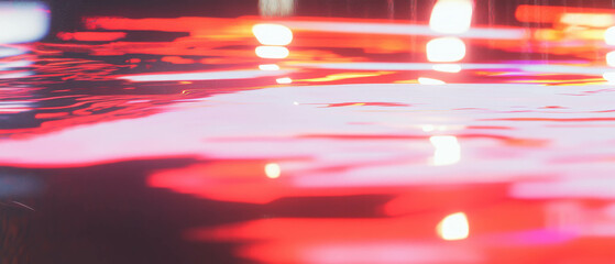 Poster - Light streaks create vibrant reflections on a wet surface during a rainy atmosphere