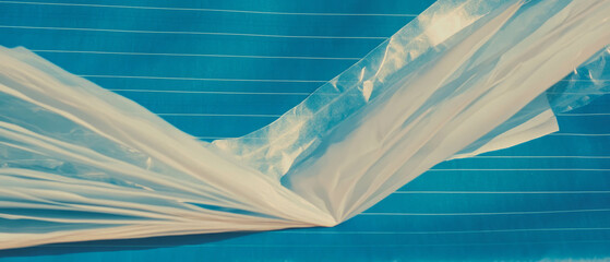 Poster - Transparent plastic sheet drapes elegantly across dark blue lined notebook paper