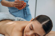 © standret - Relaxed young woman getting massage by therapist in spa salon