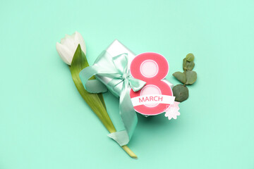 Poster - Composition with tulip flower, greeting card and gift box for Women's Day celebration on green background