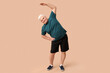 © Pixel-Shot - Sporty senior man exercising on beige background