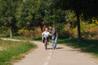 © Ljustina - Father teaching daughter riding bicycle in park during summer day