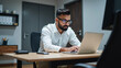 © Rick Captura - Man in Glasses Working at Desk with Laptop