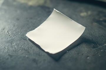 Poster - A piece of paper sits on top of a table, a simple and ordinary scene