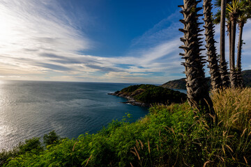 Wall Mural - Background of Phuket seaside atmosphere with bright blue sea water during tourist season or peak season, sunset viewpoint from Promthep Cape with beautiful colorful sky.