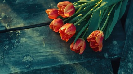 Poster - vibrant tulip bouquet arranged on rustic wooden surface showcasing natural beauty and warm tones