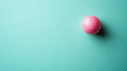 Poster - Vibrant pink chewing gum ball positioned off-center on a mint green background with ample space for creative text placement and design elements.