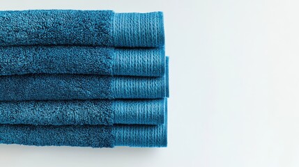 Aufkleber - Clean folded blue towels neatly stacked on a bright white background showcasing texture and color contrast for bathroom or spa decor.