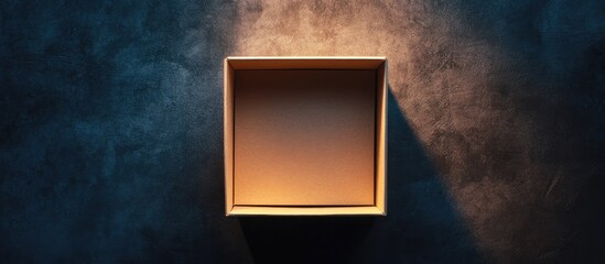 Poster - Top view of a simple brown surprise box on a dark textured surface with soft golden light casting shadows and space for creative text inclusion