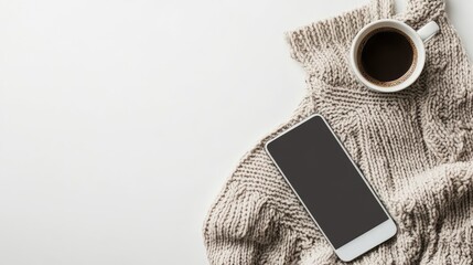 Poster - Cozy autumn flat lay featuring a gray knitted sweater, white coffee cup, and smartphone on a clean white background with ample copy space.