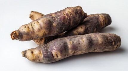 Poster - Purple tubers of potatoes displayed on a clean white background showcasing their unique texture and shape for food or agricultural themes.