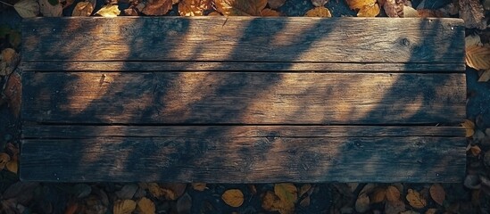 Aufkleber - Wooden tabletop in autumn forest with sunlight casting shadows and colorful leaves creating an inviting space for text or design elements