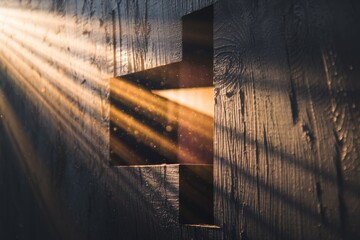 Aufkleber - Sunbeams illuminate a cross-shaped cutout in a dark wooden wall, creating a spiritual and serene atmosphere.