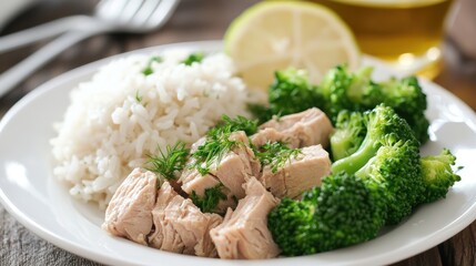 Aufkleber - Healthy Tuna Salad with Rice and Steamed Broccoli Garnished with Lemon Wedge on Plate for Nutritious Meal Preparation