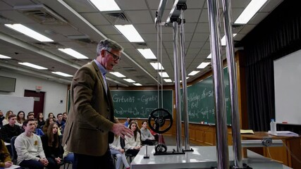 Poster - physics class demonstration on pulley systems engages students in hands-on learning experience