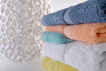 Poster - A stack of towels resting on a table, perfect for displaying or using as a decorative element