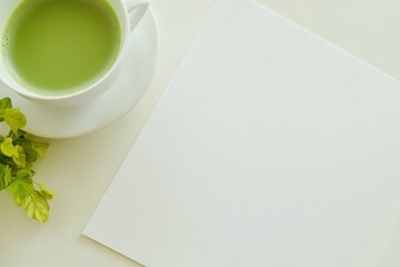 Poster - A simple setup with a cup of green tea next to a piece of paper, great for depicting a quiet moment or a study session