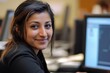 © Abdul - Professional Female Customer Service Representative Smiling While Working on a Computer in a Bright Corporate Office Environment