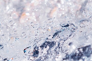 Poster - A close-up view of water splashing over rocks