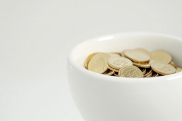 Poster - A white cup filled with a large amount of shiny gold coins
