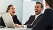 © Fotograf - A couple laughing and collaborating on a laptop, perfect for remote work or team projects